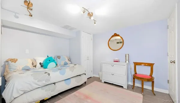 a living room with baby crib furniture and a window