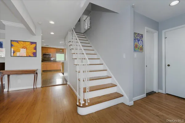 a view of entryway and hall with wooden floor
