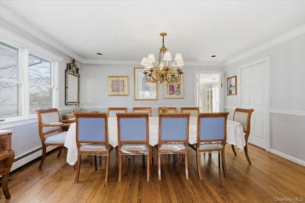 a view of a dining room with furniture wooden floor and chandelier