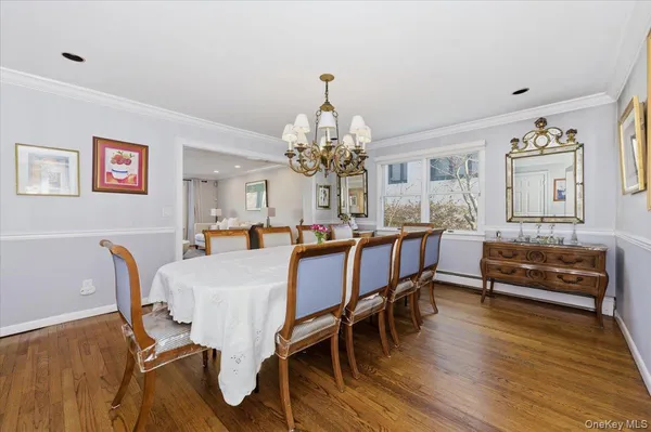 a view of a dining room with furniture wooden floor and chandelier