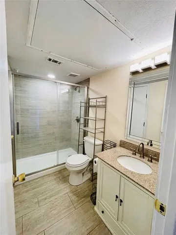 a bathroom with a sink toilet and shower