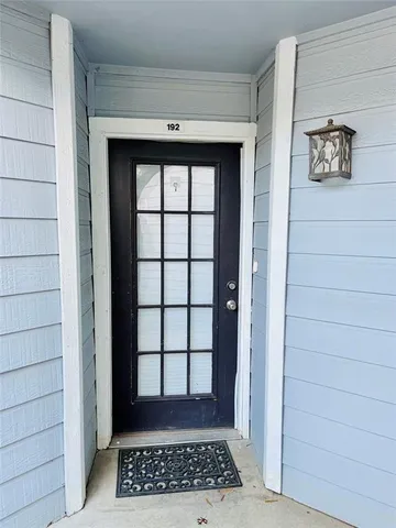 a view of a hallway with a window and a white walls