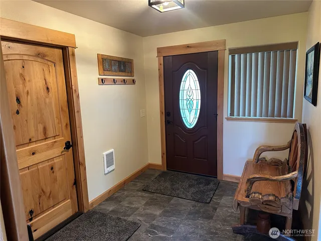 a view of a livingroom with furniture and a mirror