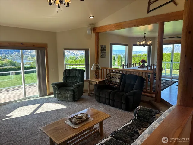 a living room with furniture and a floor to ceiling window