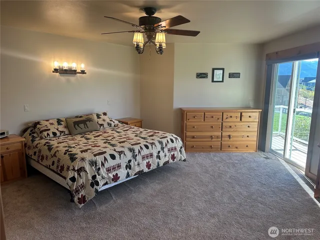 a bedroom with a bed and a ceiling fan
