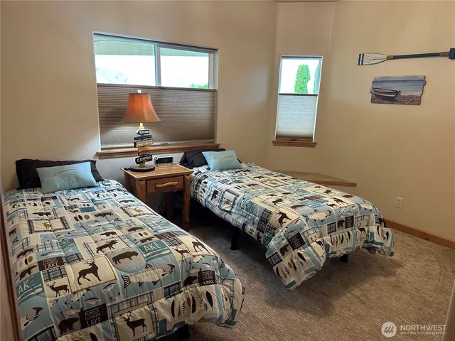 a bedroom with two beds and a window