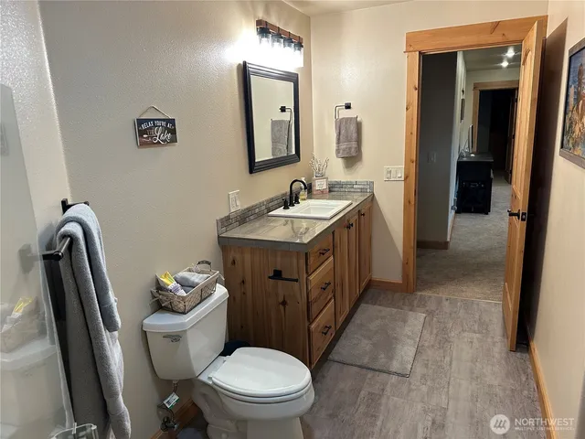 a bathroom with a toilet sink and mirror