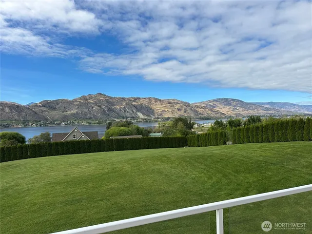 a view of a field with mountains in the background