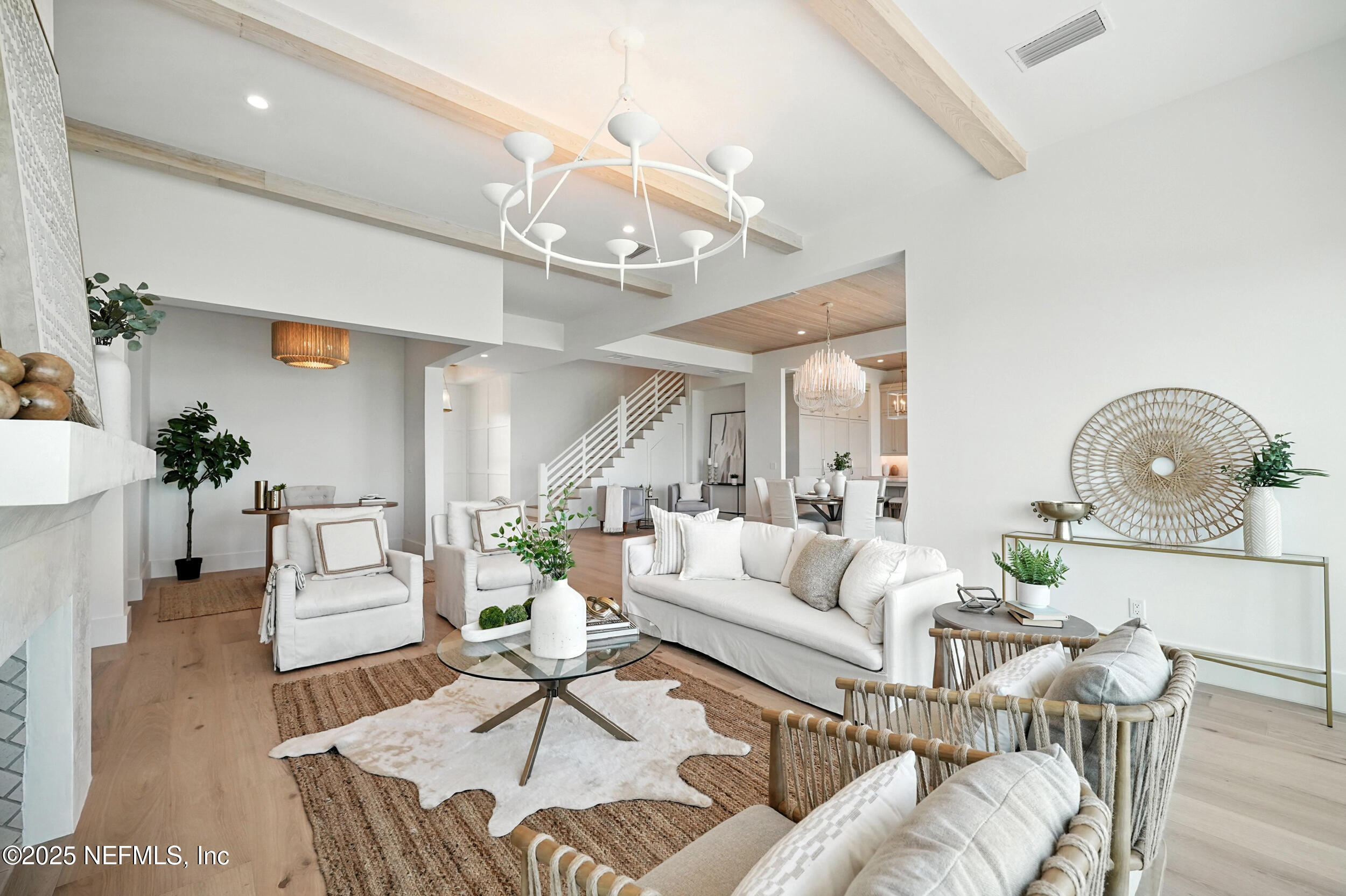 1509 Ocean Front Neptune Beach, FL 32266 - Photo 16 of 93 a living room with furniture a dining table and a chandelier