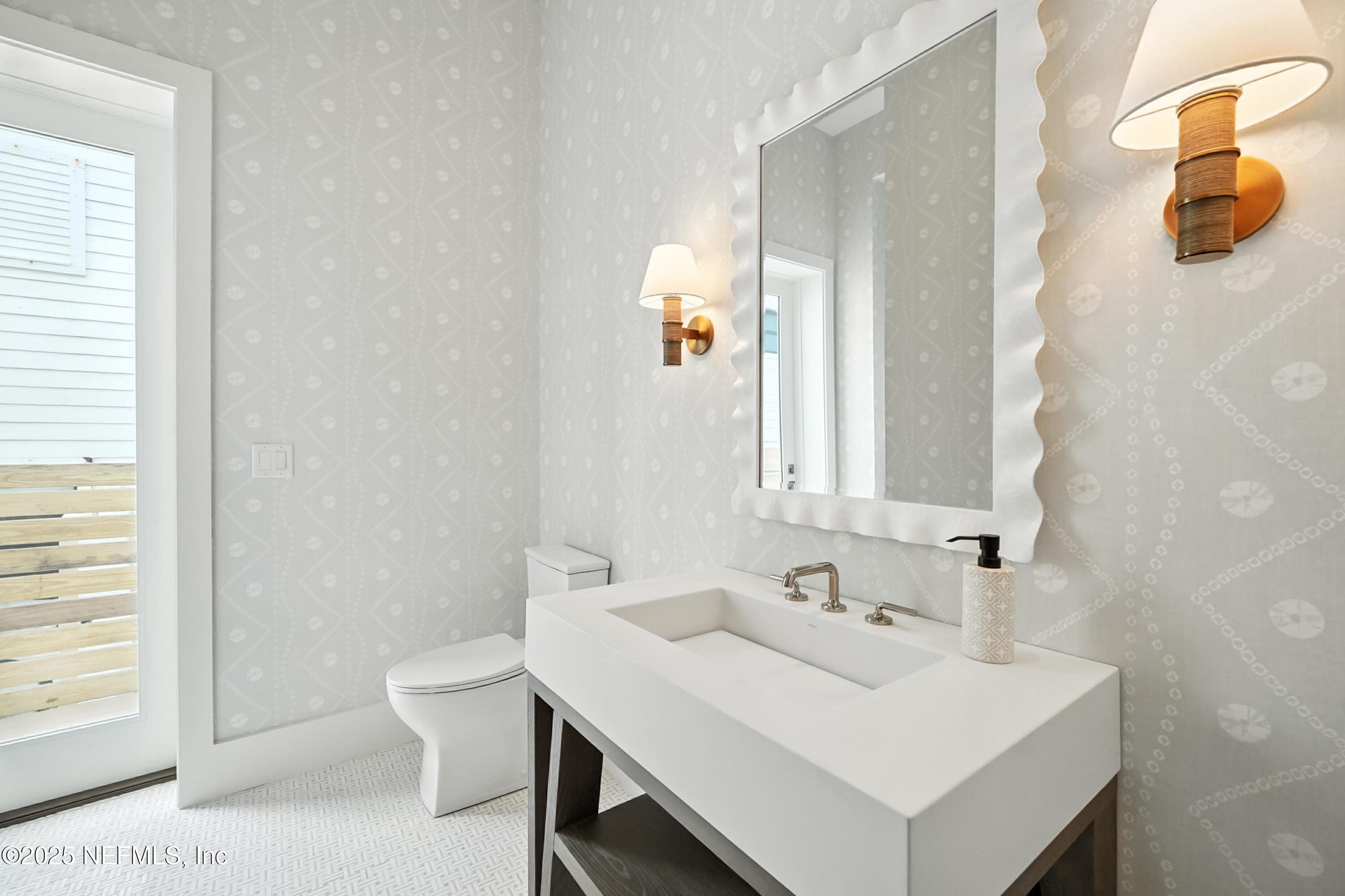 1509 Ocean Front Neptune Beach, FL 32266 - Photo 39 of 93 a bathroom with a sink a toilet and mirror