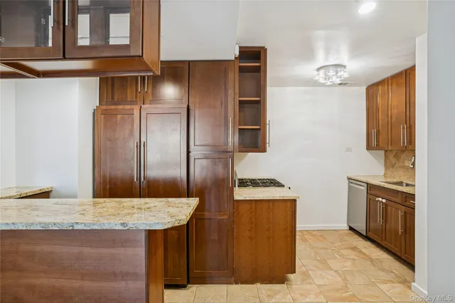 a kitchen with cabinets and stainless steel appliances