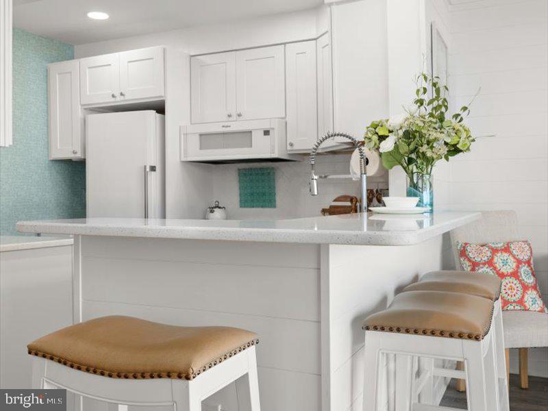 409 Annapolis House Road, Unit 409N Bethany Beach, DE 19930 - Photo 15 of 75 a kitchen with a sink and cabinets