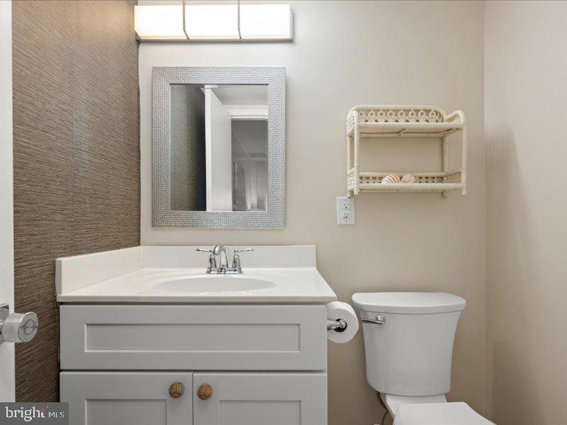 409 Annapolis House Road, Unit 409N Bethany Beach, DE 19930 - Photo 25 of 75 a bathroom with a sink a toilet and mirror