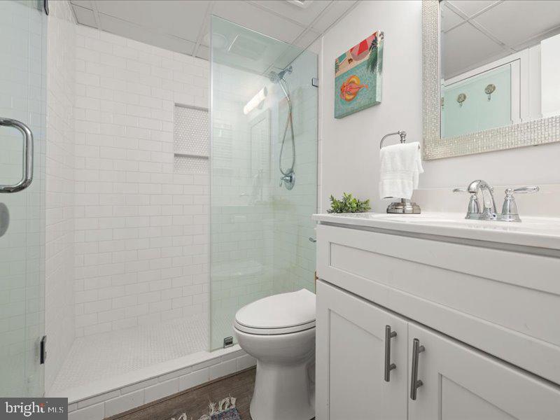 409 Annapolis House Road, Unit 409N Bethany Beach, DE 19930 - Photo 27 of 75 a bathroom with a sink mirror vanity and toilet