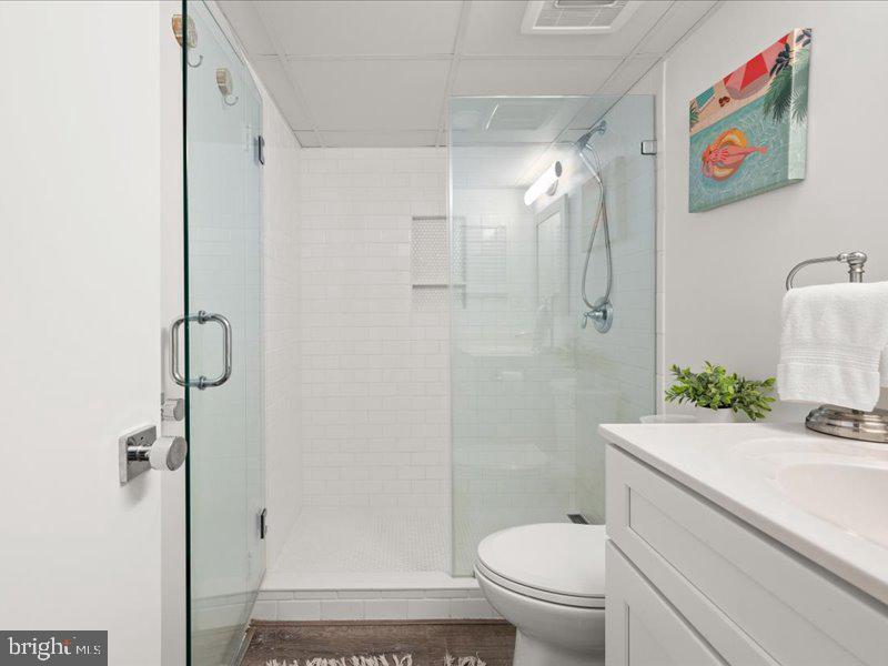 409 Annapolis House Road, Unit 409N Bethany Beach, DE 19930 - Photo 28 of 75 a bathroom with a granite countertop toilet sink and shower