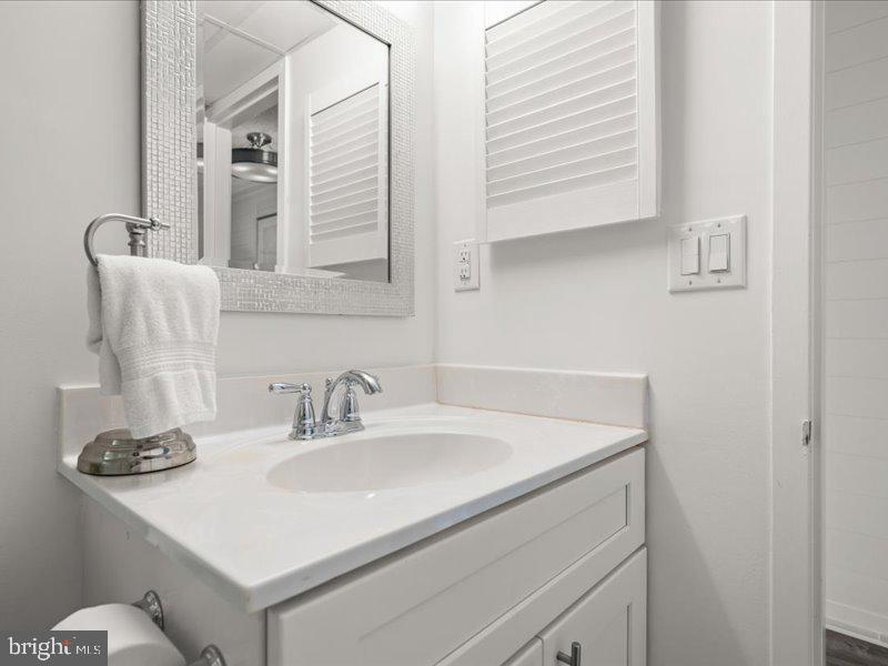 409 Annapolis House Road, Unit 409N Bethany Beach, DE 19930 - Photo 29 of 75 a bathroom with a sink and a mirror