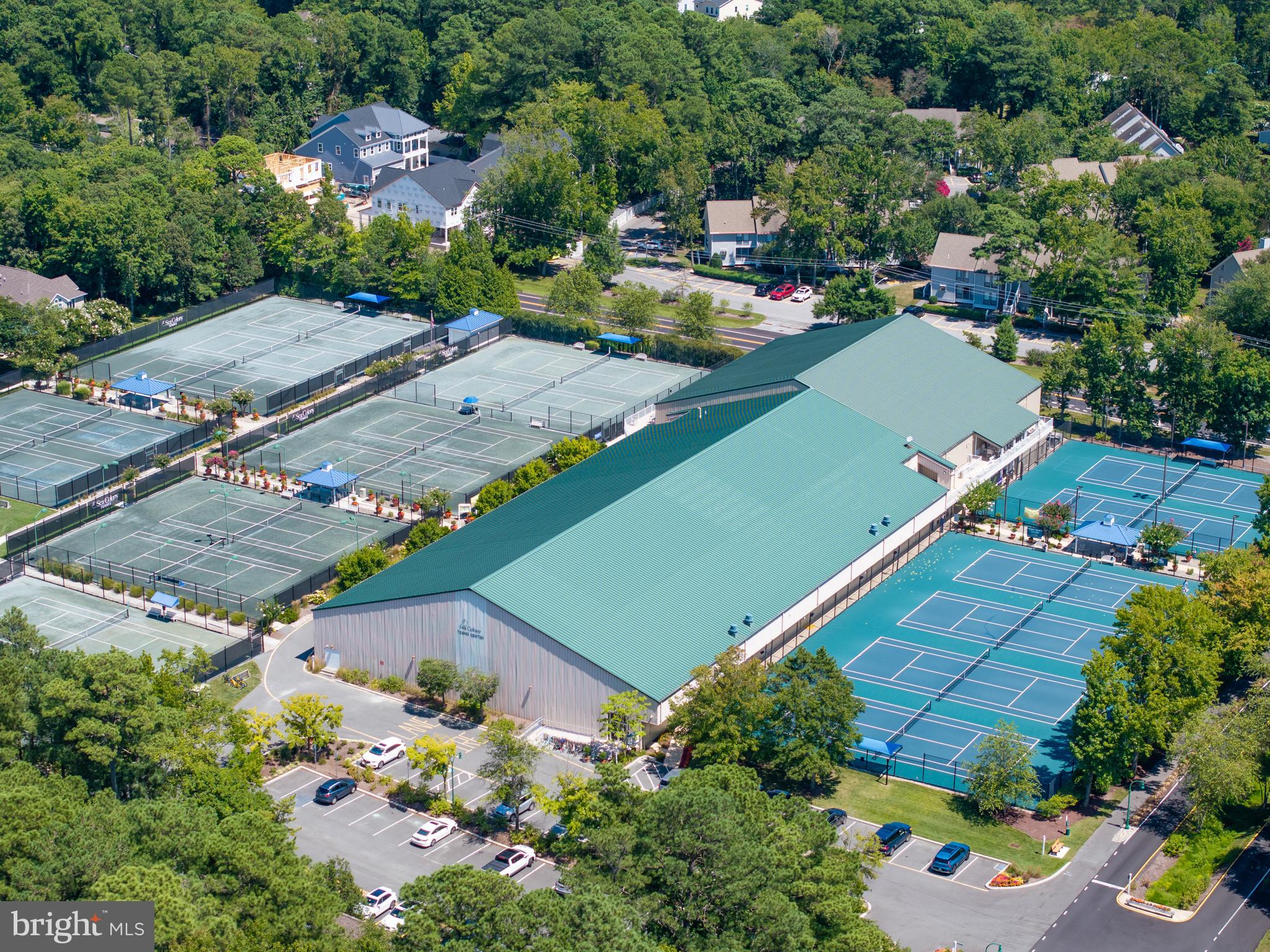 409 Annapolis House Road, Unit 409N Bethany Beach, DE 19930 - Photo 54 of 75 an aerial view of a tennis ground and a cars park side of the road