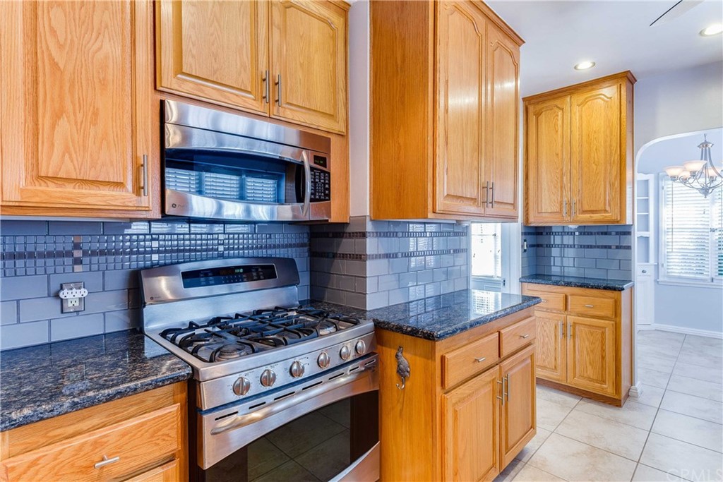 1763 Stearns Drive Los Angeles, CA 90035 - Photo 12 of 33 a kitchen with stainless steel appliances granite countertop a stove a sink and a microwave