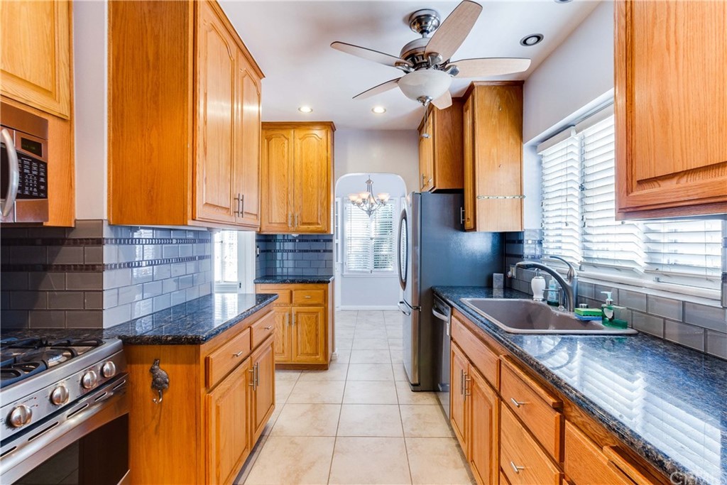 1763 Stearns Drive Los Angeles, CA 90035 - Photo 13 of 33 a kitchen with stainless steel appliances granite countertop a sink a stove and a refrigerator