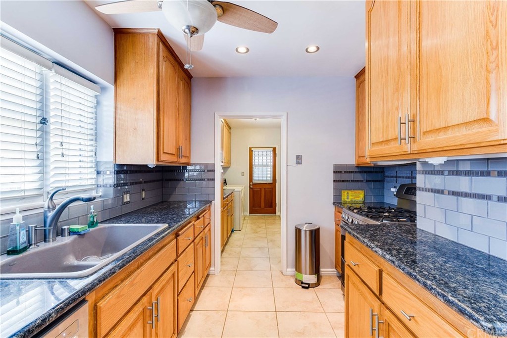 1763 Stearns Drive Los Angeles, CA 90035 - Photo 14 of 33 a kitchen with granite countertop a sink and cabinets