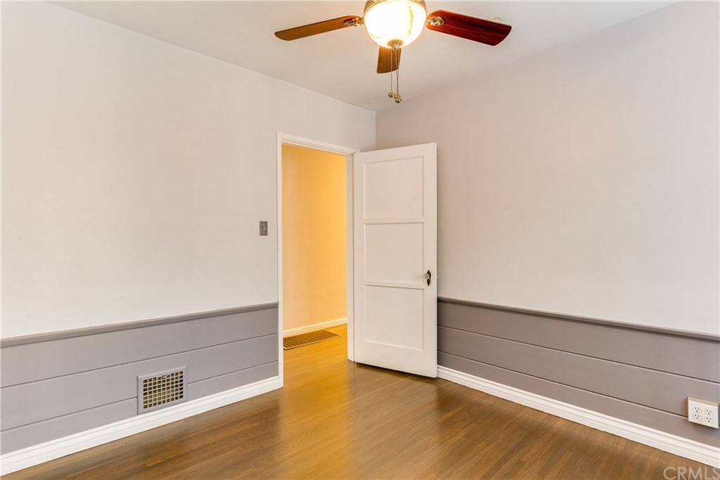 1763 Stearns Drive Los Angeles, CA 90035 - Photo 20 of 33 an empty room with wooden floor closet and ceiling fan
