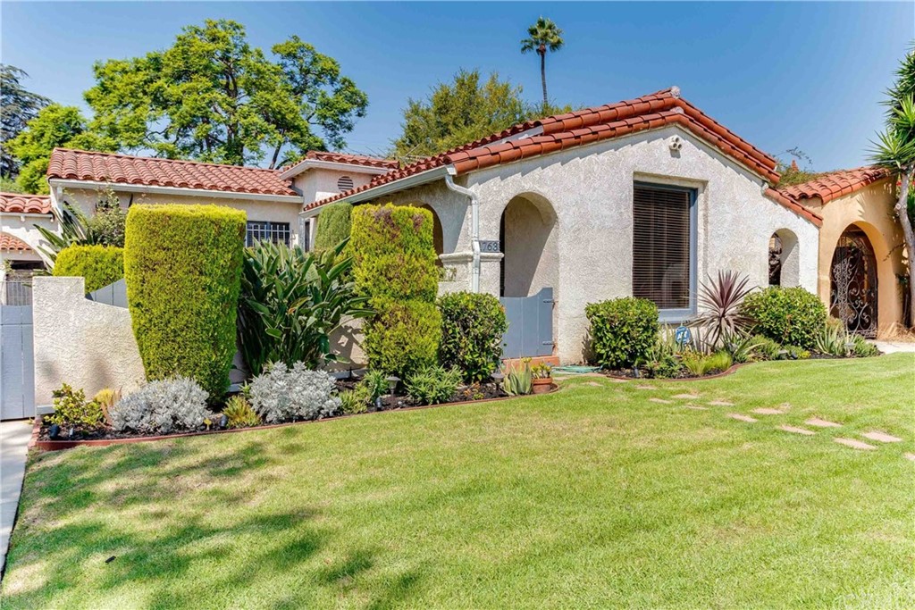 1763 Stearns Drive Los Angeles, CA 90035 - Photo 2 of 33 a front view of a house with garden