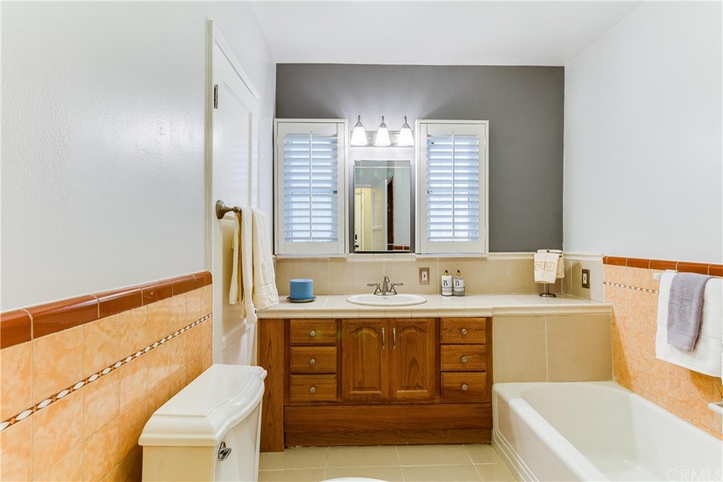 1763 Stearns Drive Los Angeles, CA 90035 - Photo 22 of 33 a bathroom with a tub sink and mirror