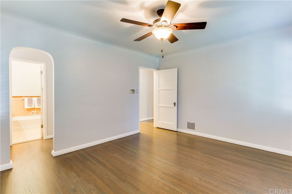 1763 Stearns Drive Los Angeles, CA 90035 - Photo 26 of 33 an empty room with wooden floor fan and windows