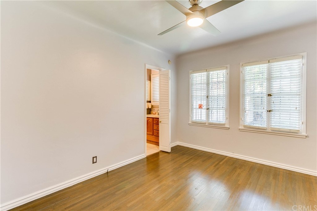1763 Stearns Drive Los Angeles, CA 90035 - Photo 27 of 33 an empty room with wooden floor and windows