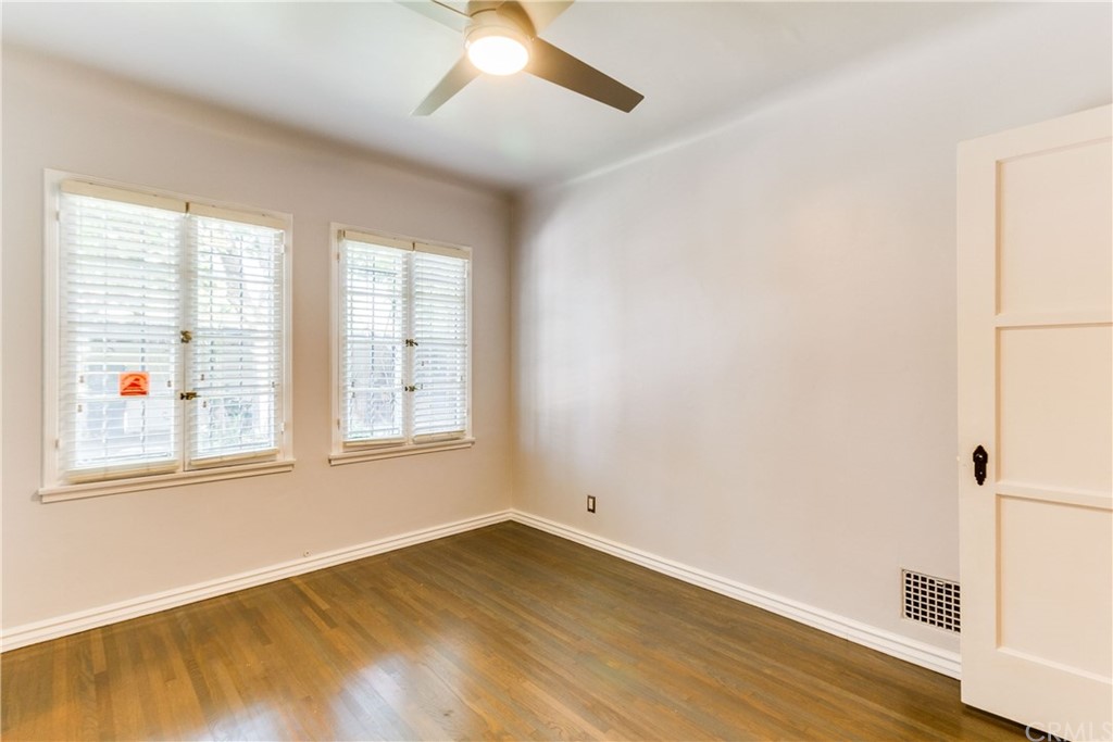 1763 Stearns Drive Los Angeles, CA 90035 - Photo 28 of 33 an empty room with wooden floor and windows