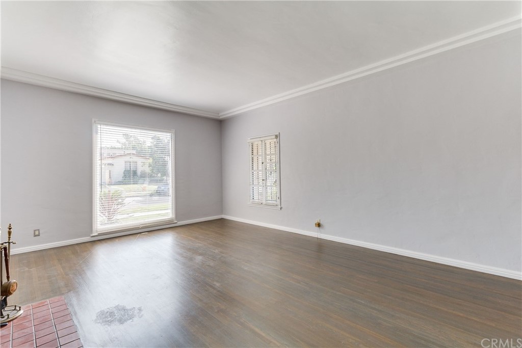 1763 Stearns Drive Los Angeles, CA 90035 - Photo 6 of 33 a view of an empty room with wooden floor and a window