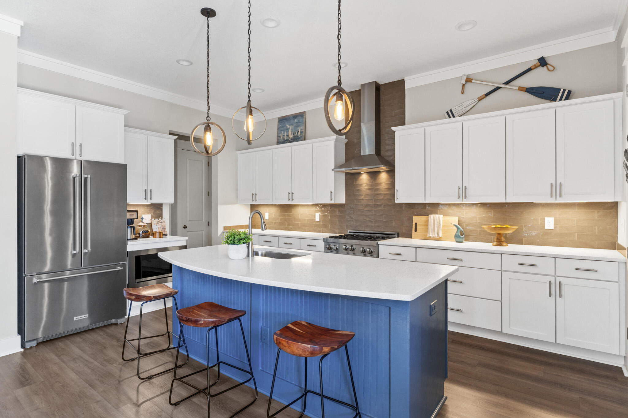 1313 North Discovery Loop Panama City, FL 32405 - Photo 12 of 50 a kitchen with wooden cabinets and stainless steel appliances