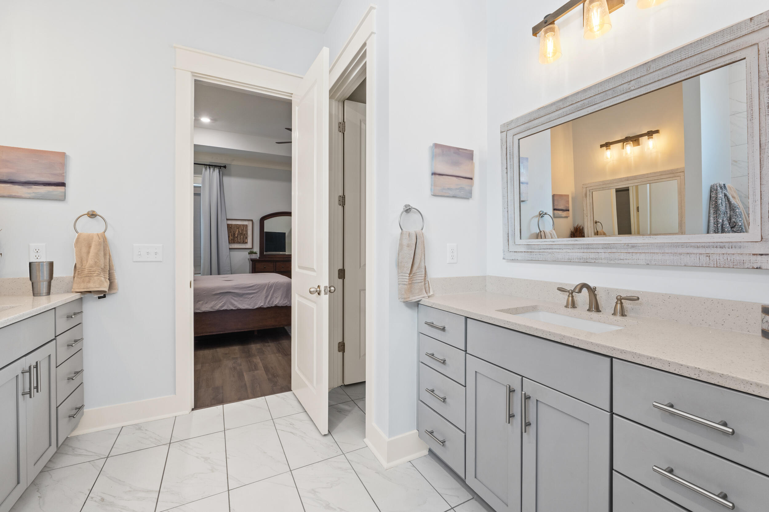 1313 North Discovery Loop Panama City, FL 32405 - Photo 16 of 50 a en suite bathroom with a sink and a mirror