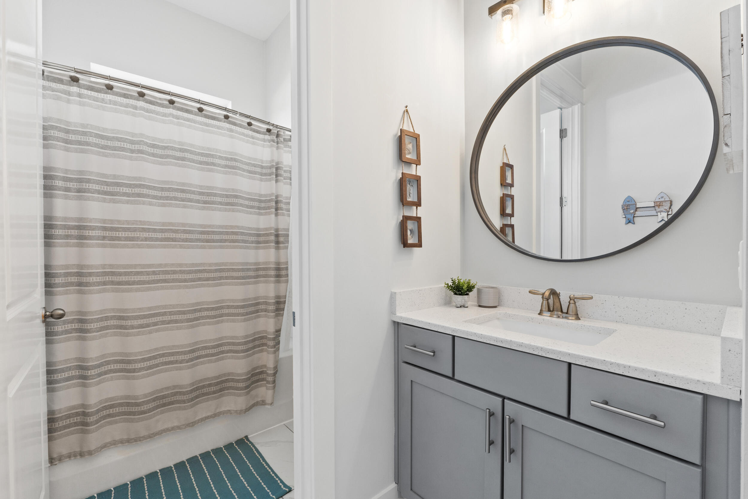 1313 North Discovery Loop Panama City, FL 32405 - Photo 23 of 50 a bathroom with a sink a mirror a vanity and a shower