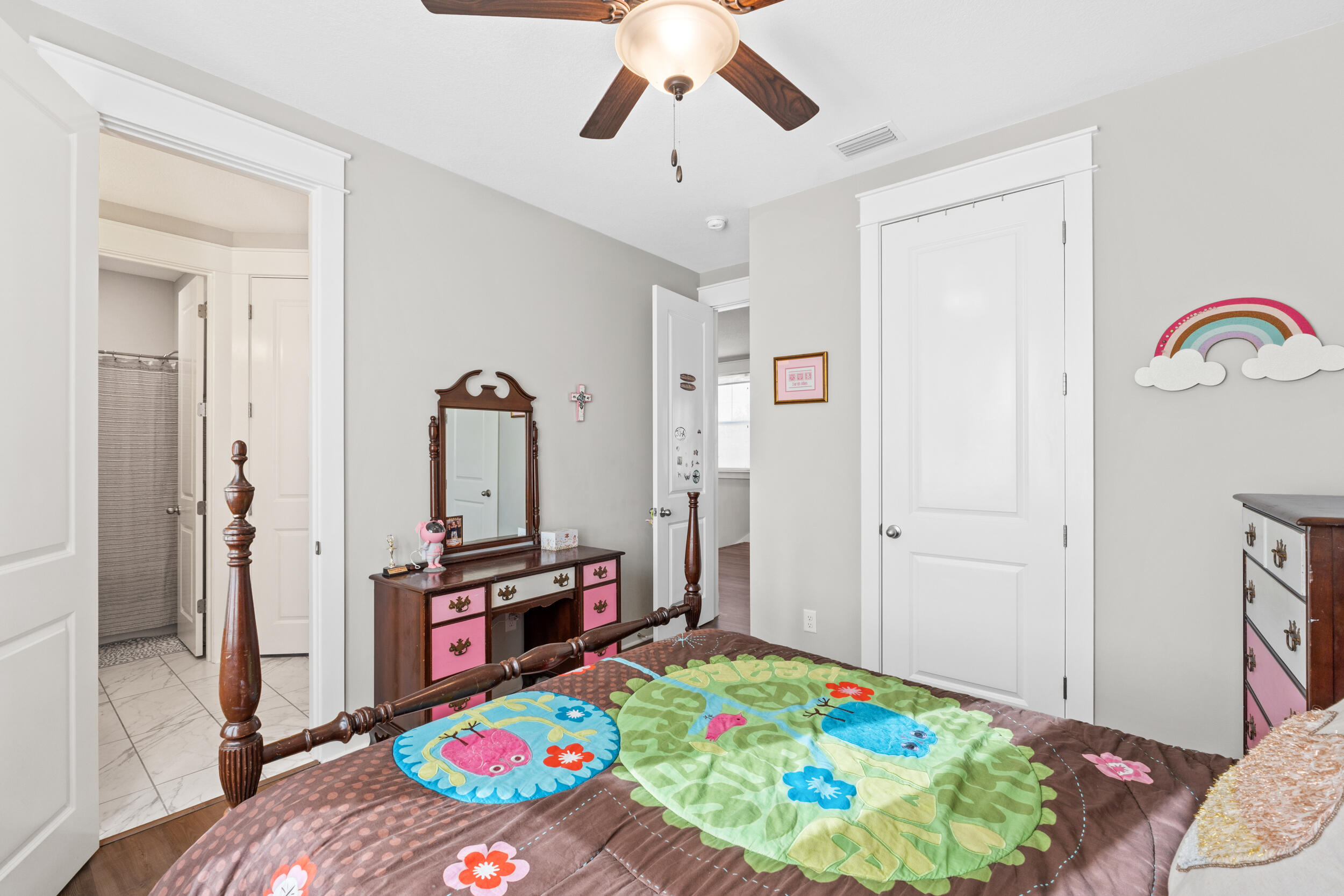1313 North Discovery Loop Panama City, FL 32405 - Photo 29 of 50 a bedroom with bed and a chandelier