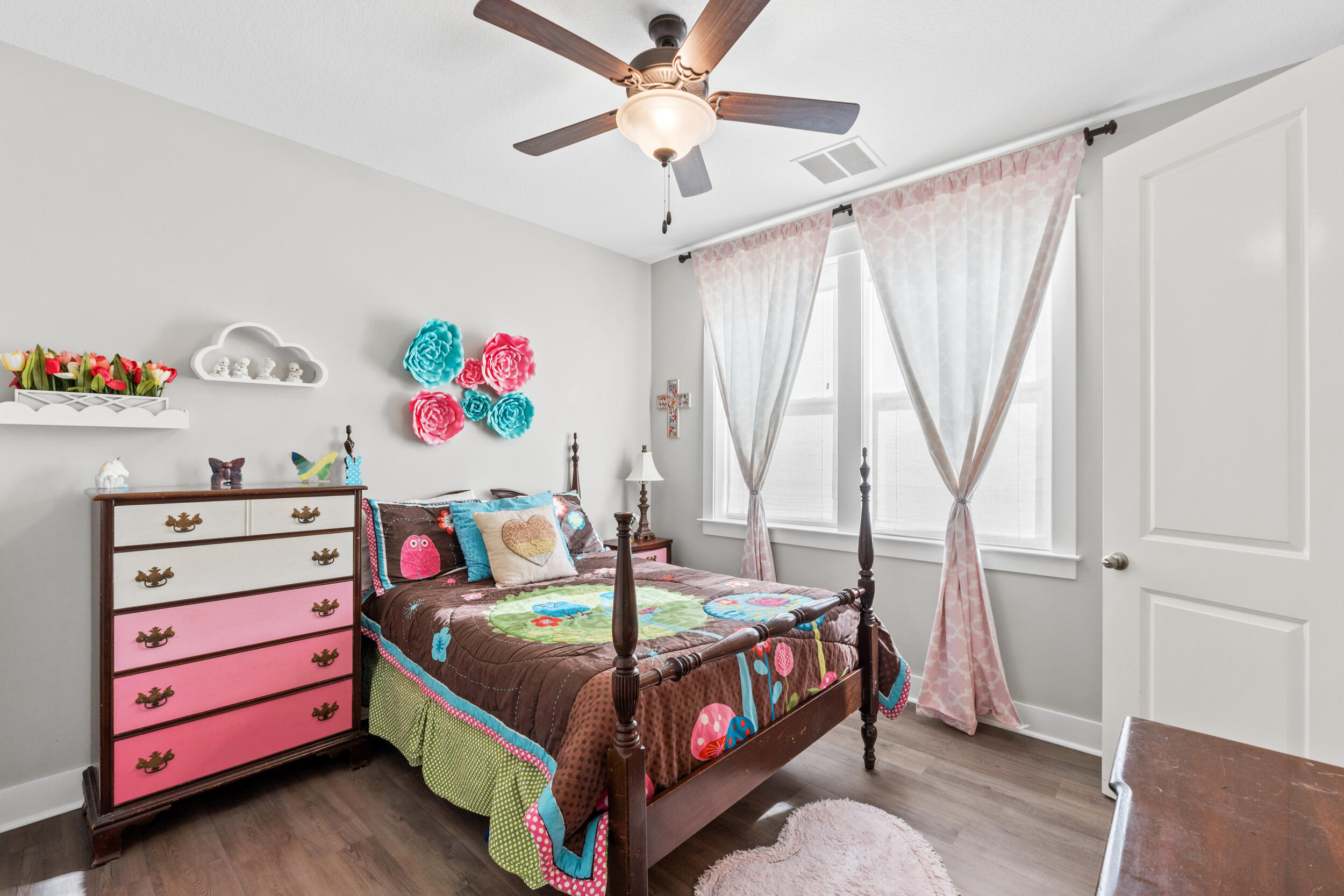 1313 North Discovery Loop Panama City, FL 32405 - Photo 30 of 50 a bedroom with a bed and a chandelier