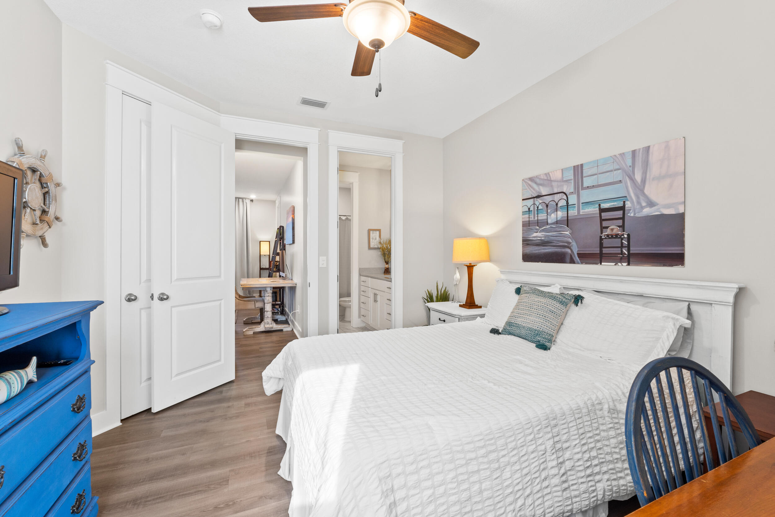 1313 North Discovery Loop Panama City, FL 32405 - Photo 33 of 50 a bedroom with a bed and wooden floor