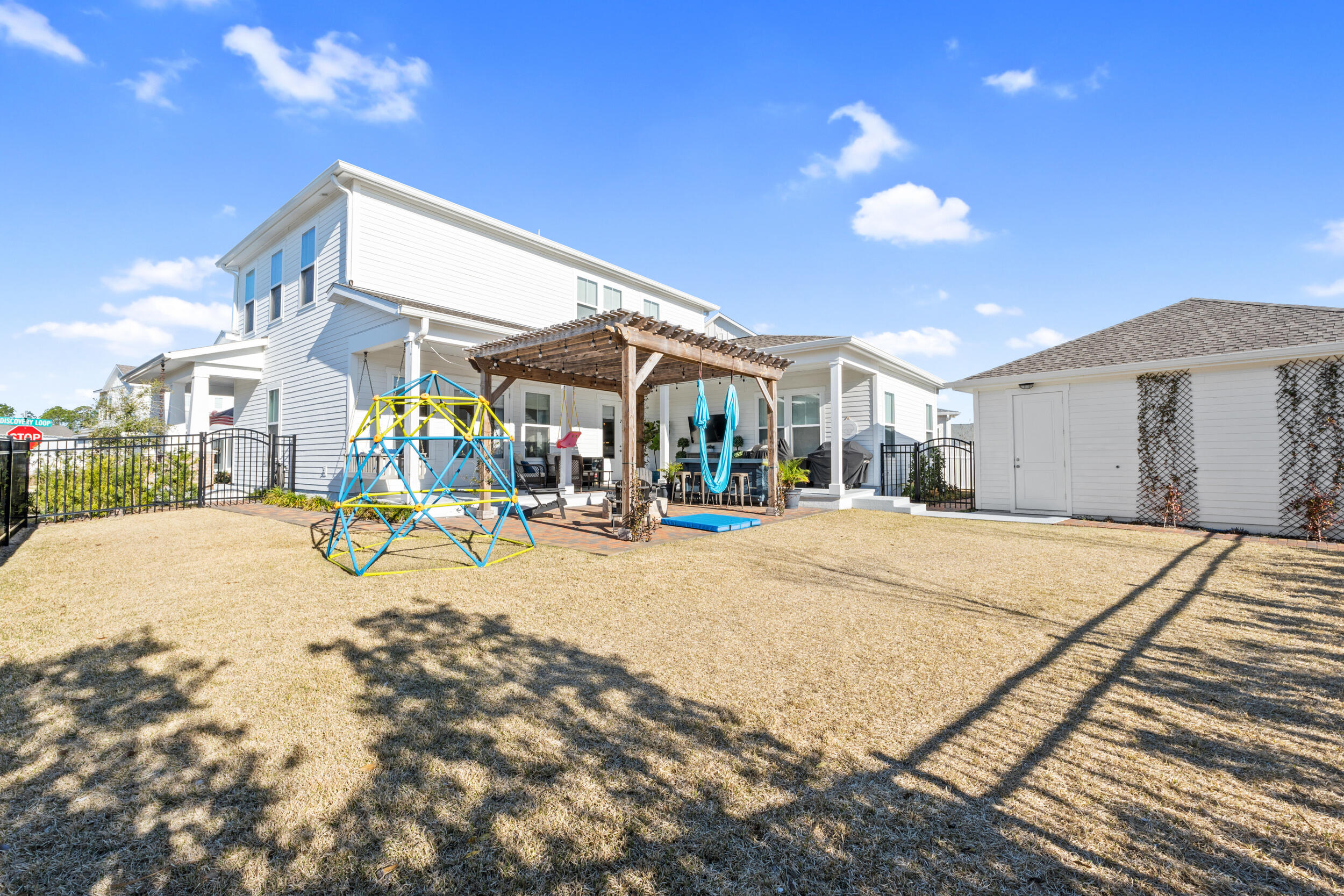 1313 North Discovery Loop Panama City, FL 32405 - Photo 39 of 50 a swimming pool with outdoor seating and yard