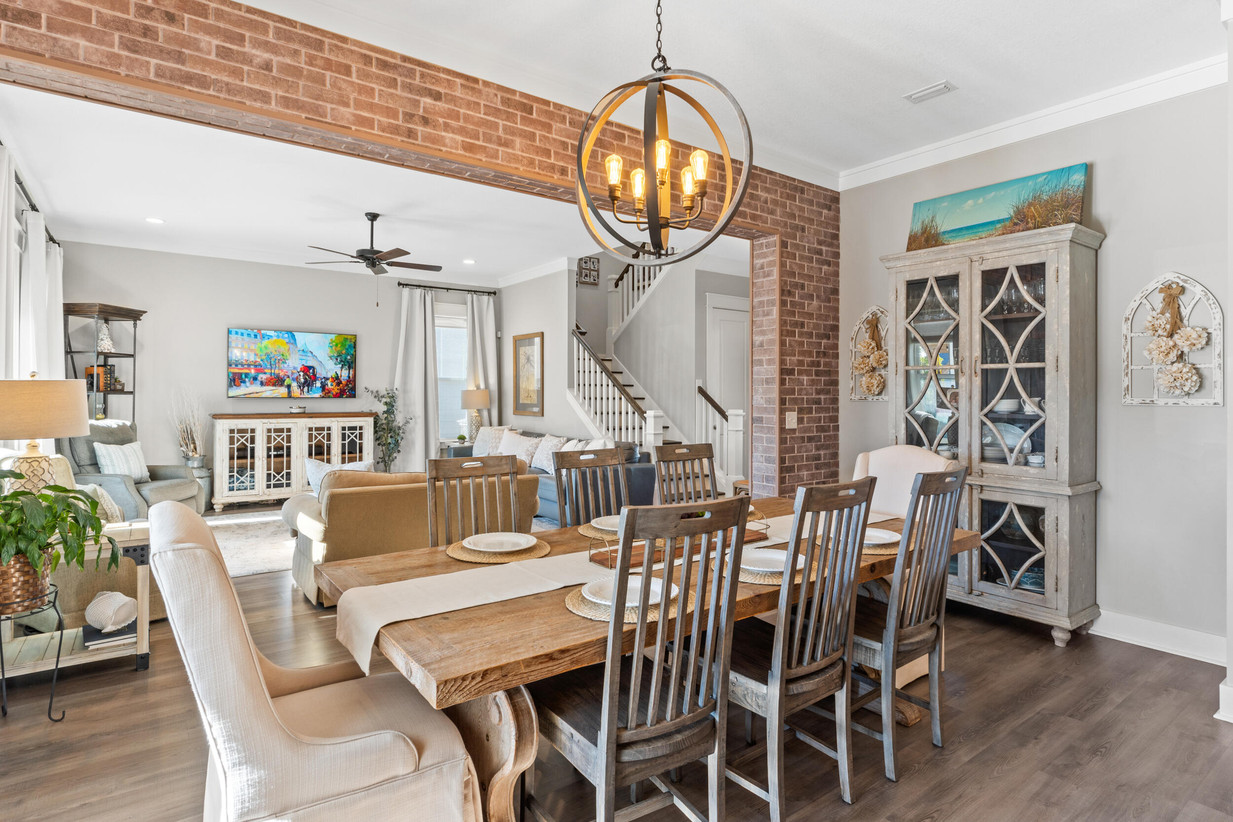 1313 North Discovery Loop Panama City, FL 32405 - Photo 10 of 50 a dining room with furniture a chandelier and wooden floor