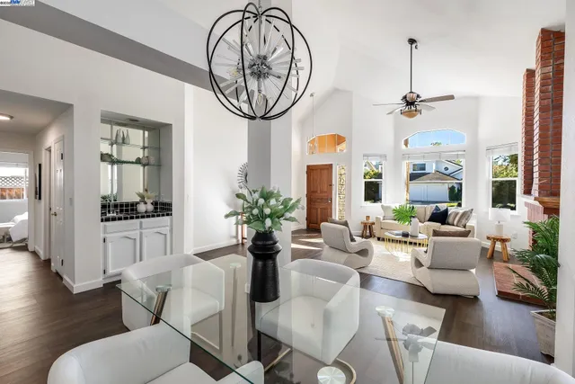 a living room with furniture a chandelier and a large mirror