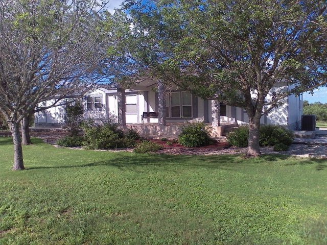 2991 Elm Creek Road Seguin, TX 78155 - Photo 1 of 1 a front view of a house with garden and trees