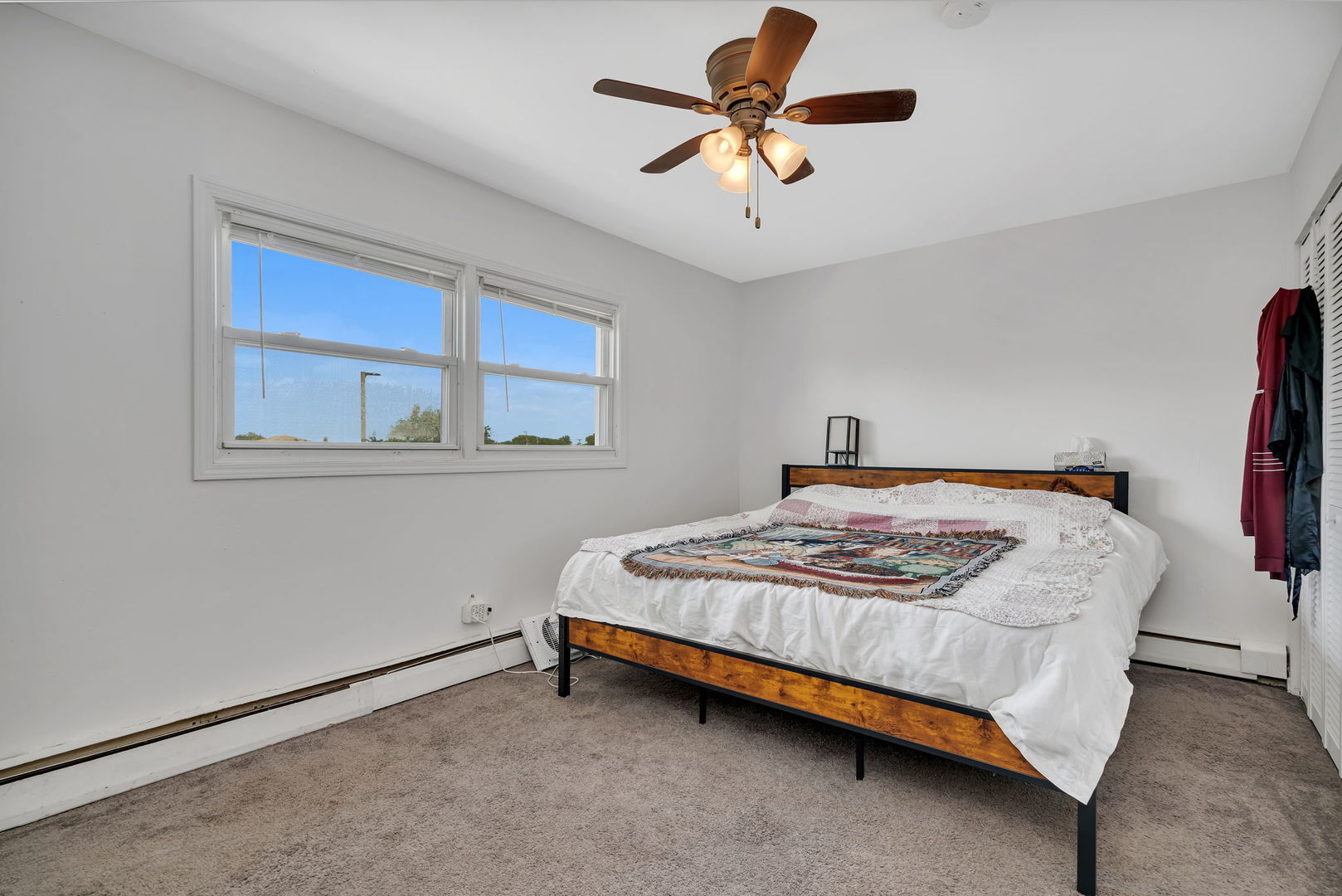 8010 West 84th Street Justice, IL 60458 - Photo 18 of 32 a bedroom with a bed a window and a chandelier