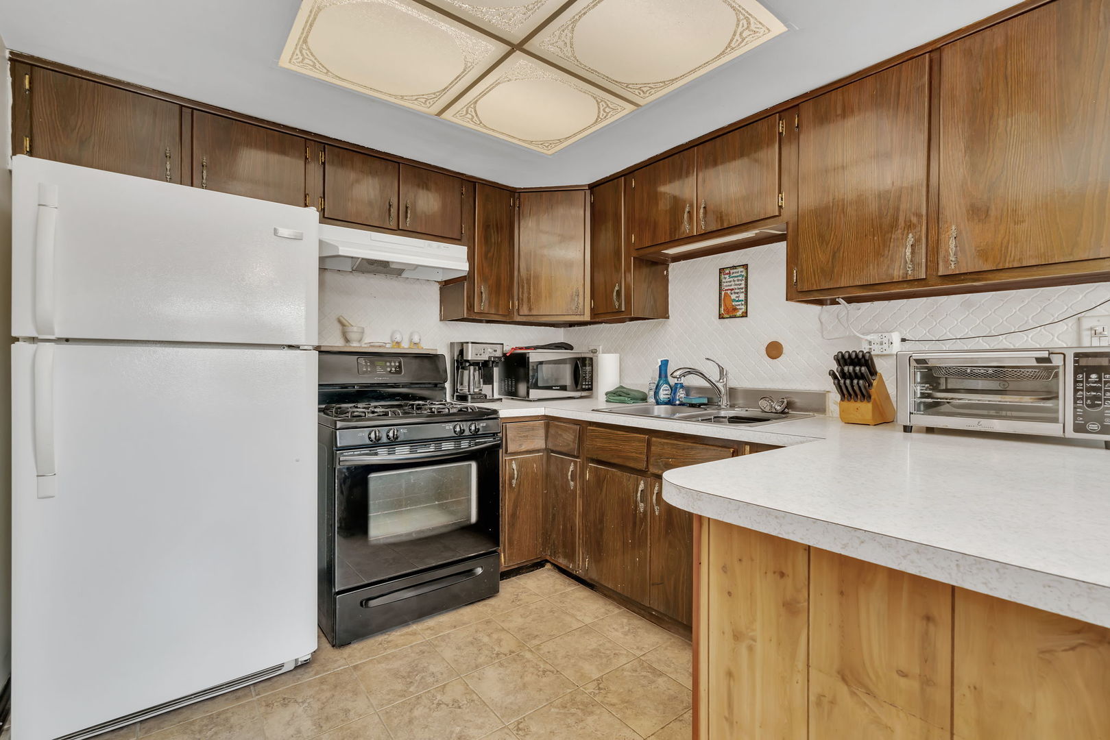 8010 West 84th Street Justice, IL 60458 - Photo 24 of 32 a kitchen with stainless steel appliances a stove a sink and a refrigerator