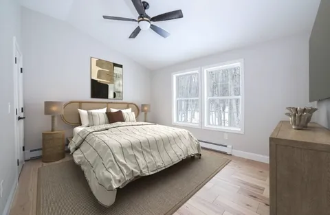 a spacious bedroom with a bed and a window