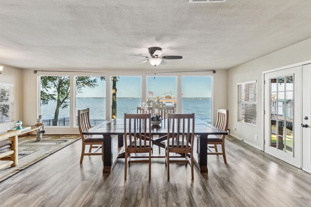 142 Peninsula Point Terrace Mabank, TX 75156 - Photo 5 of 29 a view of a dining room with furniture window and wooden floor
