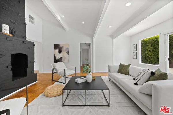 a living room with furniture fireplace and window