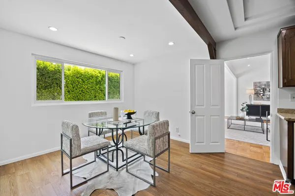 a view of a dining room with furniture and a wooden floor