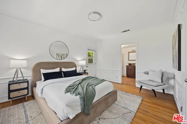 a bedroom with a bed and lamp