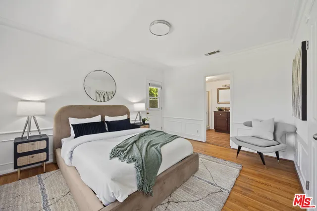 a bedroom with a bed and lamp