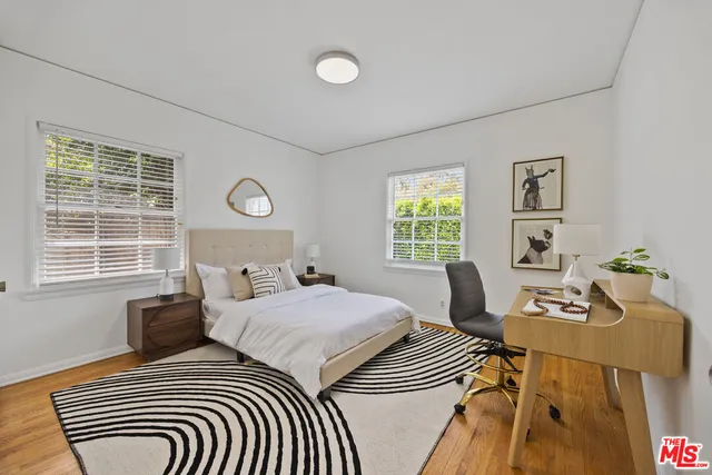 a bedroom with two beds and a window